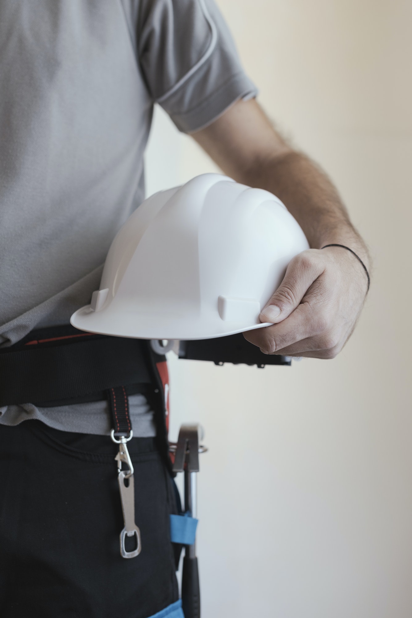 Construction worker holding a safety helmet